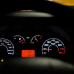 VW Jetta interior with driver using dashboard controls to reset the oil change light