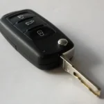 Lincoln MKX parked in a driveway with an owner holding a dead key fob beside the driver door