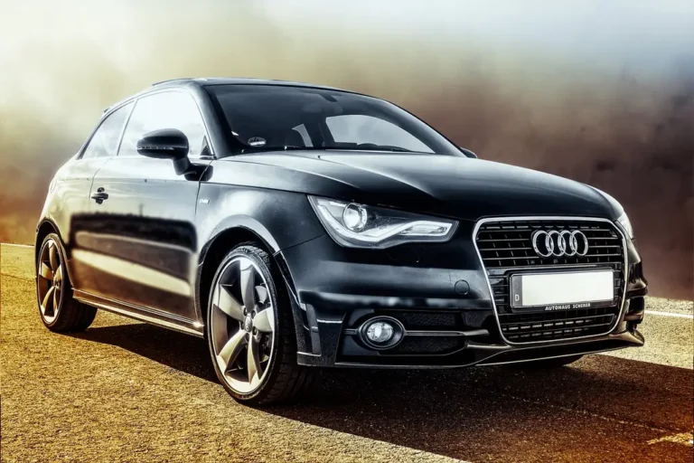 Used Volvo S60 and Audi A4 parked side by side with a buyer and mechanic comparing them