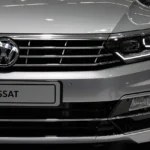 Used VW Passat on a dealership lot with a buyer and mechanic inspecting it