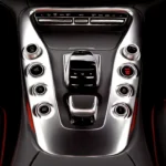Lincoln MKX interior with driver holding a key fob near the start button and dashboard lit